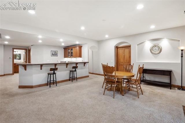 1230 Cottontail Trl, Woodland Park, CO 80863 - dining room with wet bar, recessed lighting, light colored carpet, and baseboards