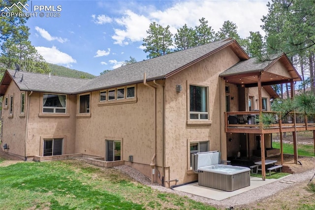 1230 Cottontail Trl, Woodland Park, CO 80863 - rear view of property featuring a lawn, a deck, stucco siding, a shingled roof, and a patio area