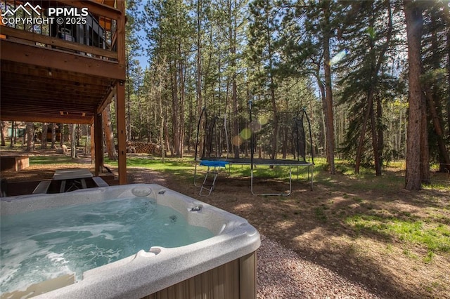 1230 Cottontail Trl, Woodland Park, CO 80863 - view of yard with a trampoline, a hot tub, and a deck