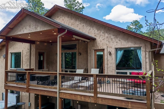 1230 Cottontail Trl, Woodland Park, CO 80863 - view of front of home with stucco siding and a wooden deck