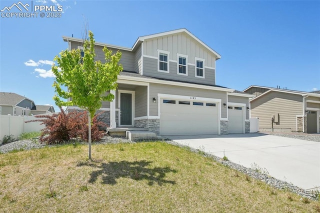 1145 Ibex Dr, Severance, CO 80550 - view of front of home featuring board and batten siding, concrete driveway, an attached garage, and stone siding