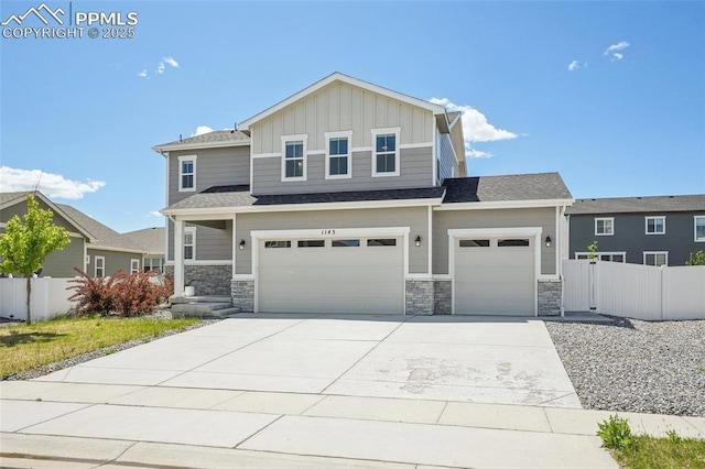 1145 Ibex Dr, Severance, CO 80550 - view of front of home featuring board and batten siding, concrete driveway, stone siding, a garage, and an attached garage