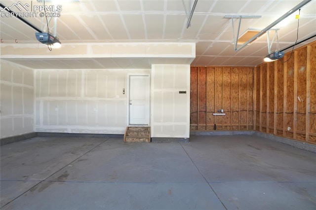 1145 Ibex Dr, Severance, CO 80550 - garage with a garage door opener, baseboards, and wooden walls