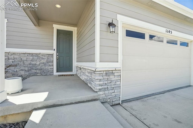 1145 Ibex Dr, Severance, CO 80550 - view of exterior entry featuring stone siding and a garage
