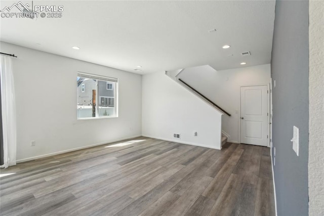 1145 Ibex Dr, Severance, CO 80550 - unfurnished living room with stairs, wood finished floors, recessed lighting, and baseboards