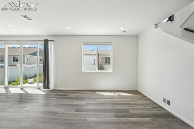1145 Ibex Dr, Severance, CO 80550 - unfurnished room featuring healthy amount of natural light, wood finished floors, baseboards, and recessed lighting