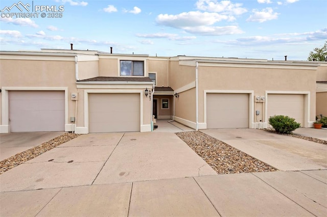 6947 Gayle Lyn Ln, Colorado Springs, CO 80919 - view of front of house with stucco siding and driveway