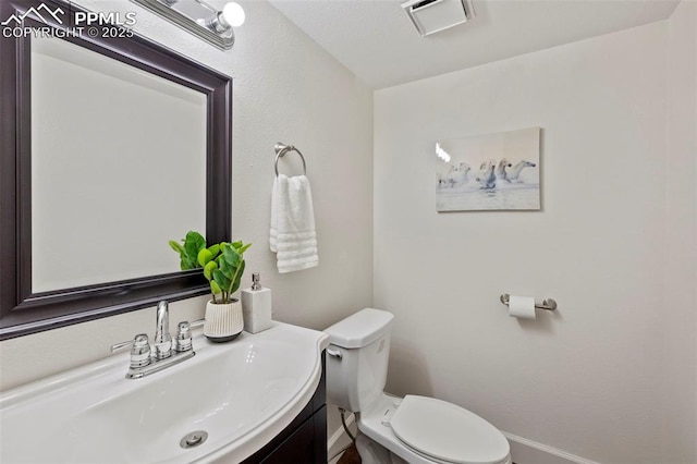 6947 Gayle Lyn Ln, Colorado Springs, CO 80919 - half bathroom with vanity, toilet, and baseboards