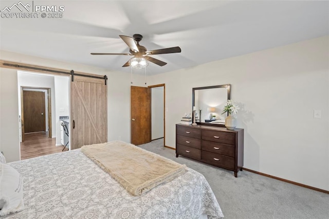 6947 Gayle Lyn Ln, Colorado Springs, CO 80919 - bedroom featuring a barn door, baseboards, light colored carpet, and ceiling fan