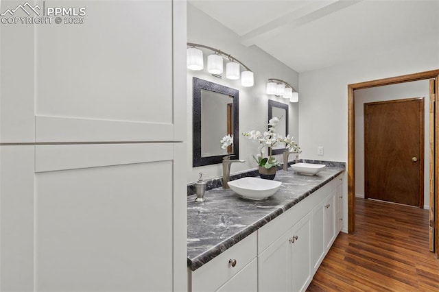 6947 Gayle Lyn Ln, Colorado Springs, CO 80919 - bathroom featuring double vanity and wood finished floors