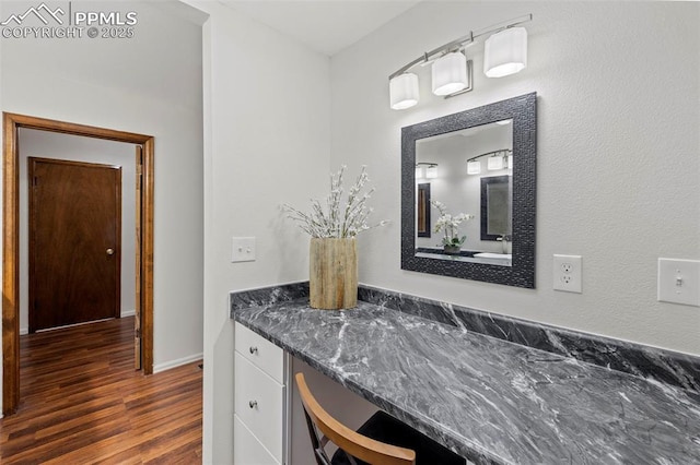 6947 Gayle Lyn Ln, Colorado Springs, CO 80919 - bathroom featuring wood finished floors, vanity, and baseboards