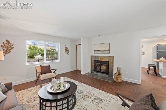 6947 Gayle Lyn Ln, Colorado Springs, CO 80919 - living room featuring wood finished floors, a fireplace, and baseboards