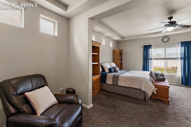 7890 Treehouse Ter, Fountain, CO 80817 - bedroom featuring dark colored carpet, a tray ceiling, multiple windows, and ceiling fan