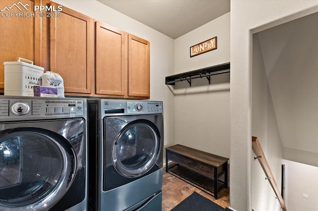 7890 Treehouse Ter, Fountain, CO 80817 - washroom with independent washer and dryer, cabinet space, and a textured ceiling