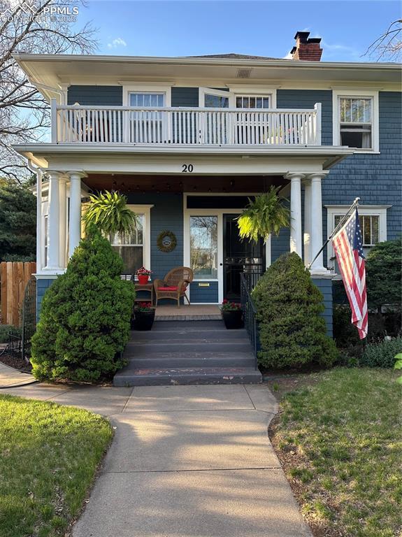 20 W Caramillo St, Colorado Springs, CO 80907 - entrance to property with a balcony, a porch, a chimney, and fence