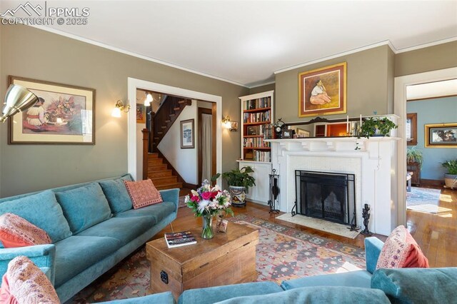 20 W Caramillo St, Colorado Springs, CO 80907 - living area with wood finished floors, crown molding, a fireplace, stairs, and baseboards