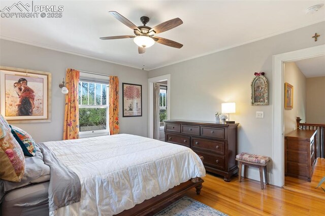 20 W Caramillo St, Colorado Springs, CO 80907 - bedroom with light wood-style floors, ornamental molding, and ceiling fan