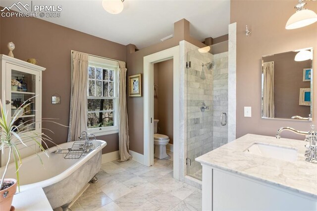 20 W Caramillo St, Colorado Springs, CO 80907 - bathroom featuring a stall shower, toilet, a freestanding tub, and vanity
