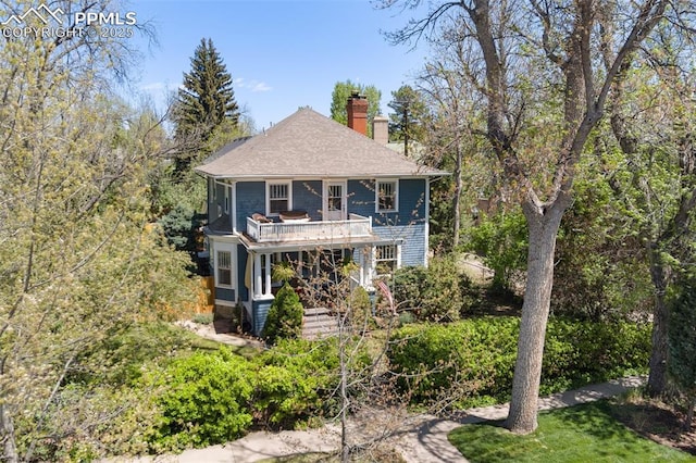 20 W Caramillo St, Colorado Springs, CO 80907 - view of front of home featuring a chimney, a balcony, and a shingled roof