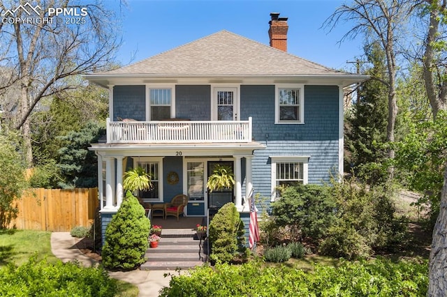 20 W Caramillo St, Colorado Springs, CO 80907 - view of front of property featuring a balcony, covered porch, a chimney, fence, and roof with shingles