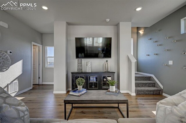7371 Cornice Pt, Colorado Springs, CO 80923 - living room featuring wood finished floors, stairs, baseboards, and recessed lighting