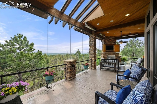 1624 Oakmoor Hts, Colorado Springs, CO 80906 - view of patio / terrace with an outdoor stone fireplace and a balcony