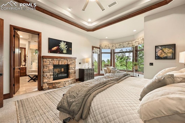 1624 Oakmoor Hts, Colorado Springs, CO 80906 - bedroom featuring recessed lighting, a fireplace, ensuite bath, and a tray ceiling