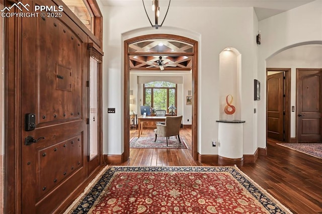 1624 Oakmoor Hts, Colorado Springs, CO 80906 - foyer entrance featuring arched walkways, dark wood-type flooring, baseboards, and ceiling fan
