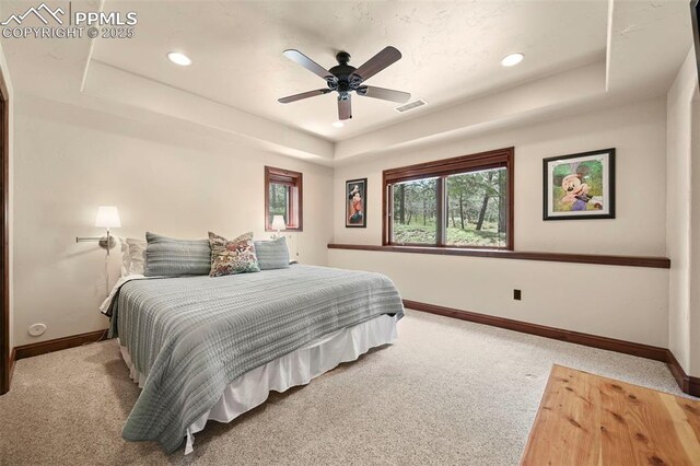 1624 Oakmoor Hts, Colorado Springs, CO 80906 - carpeted bedroom featuring a raised ceiling, baseboards, multiple windows, recessed lighting, and ceiling fan