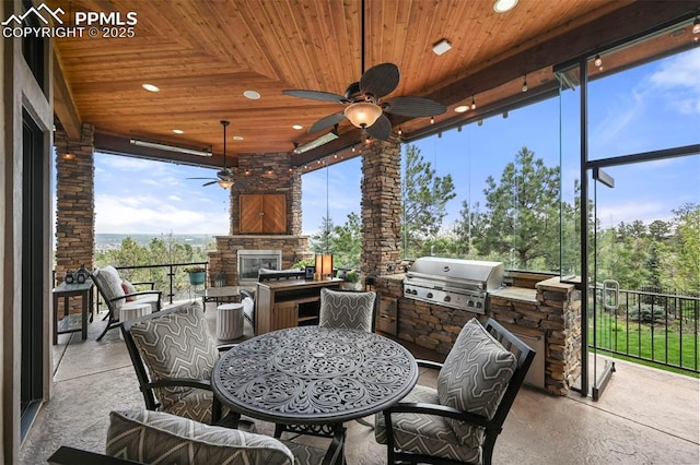 1624 Oakmoor Hts, Colorado Springs, CO 80906 - view of patio with area for grilling, a grill, outdoor dining area, an outdoor stone fireplace, and a ceiling fan