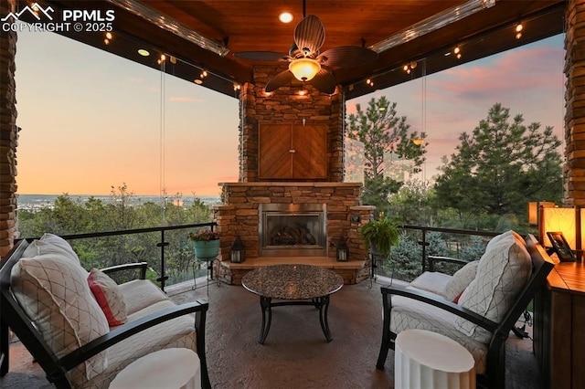 1624 Oakmoor Hts, Colorado Springs, CO 80906 - balcony at dusk featuring an outdoor living space with a fireplace