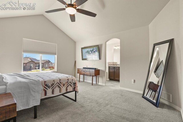 13124 Park Meadows Dr, Peyton, CO 80831 - bedroom featuring vaulted ceiling, light carpet, arched walkways, baseboards, and connected bathroom