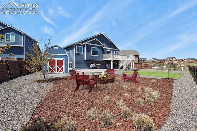 13124 Park Meadows Dr, Peyton, CO 80831 - back of house featuring a shed, a fenced backyard, an outdoor fire pit, and board and batten siding