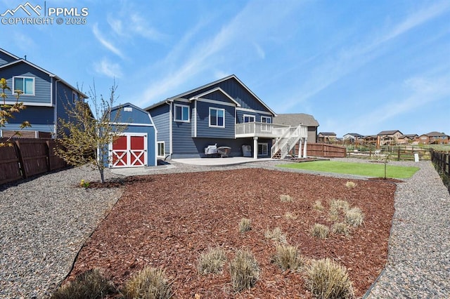 13124 Park Meadows Dr, Peyton, CO 80831 - back of property with a storage unit, a fenced backyard, a patio area, and an outbuilding