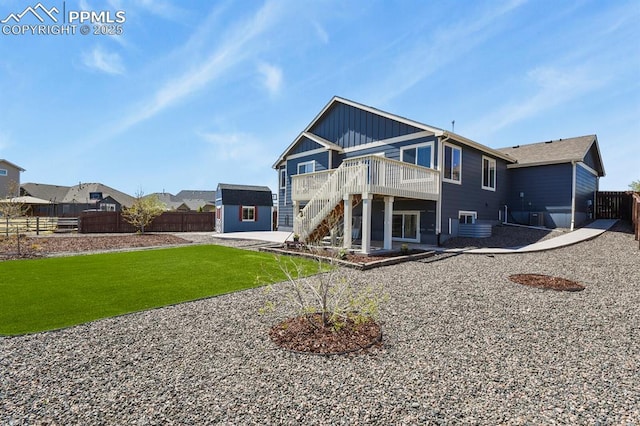 13124 Park Meadows Dr, Peyton, CO 80831 - back of property with a deck, stairs, a patio, board and batten siding, and an outdoor structure