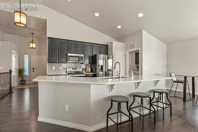 13124 Park Meadows Dr, Peyton, CO 80831 - kitchen with appliances with stainless steel finishes, light countertops, dark wood-style floors, a sink, and a spacious island