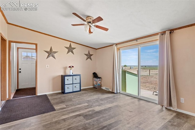 10635 Via Vaquaro Pt, Fountain, CO 80817 - unfurnished room with wood finished floors, crown molding, ceiling fan, vaulted ceiling, and baseboards