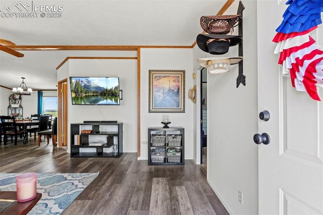 10635 Via Vaquaro Pt, Fountain, CO 80817 - living room featuring wood finished floors, a chandelier, and baseboards