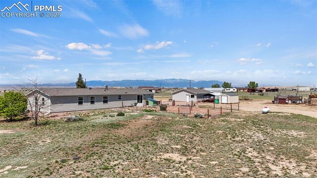 10635 Via Vaquaro Pt, Fountain, CO 80817 - view of yard with a mountain view, fence, an outbuilding, and a storage shed