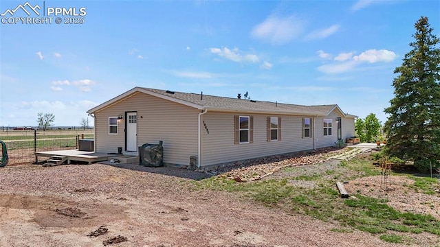 10635 Via Vaquaro Pt, Fountain, CO 80817 - view of side of home with fence and a wooden deck