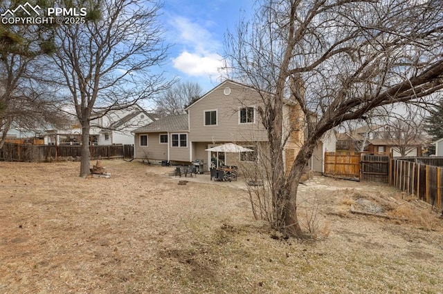 6424 Rifle Cir, Colorado Springs, CO 80919 - back of house featuring a fenced backyard, a patio, a shingled roof, and entry steps