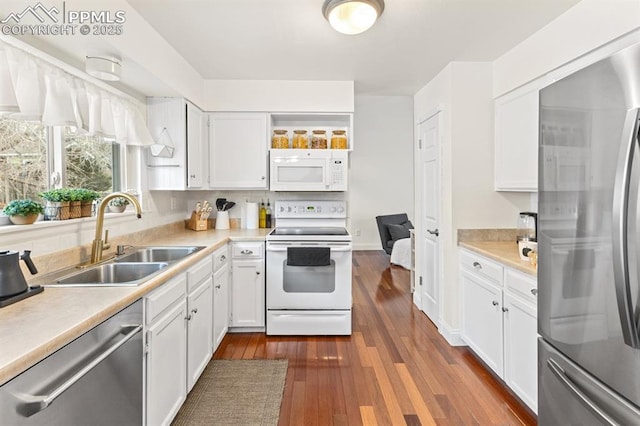 6424 Rifle Cir, Colorado Springs, CO 80919 - kitchen featuring appliances with stainless steel finishes, white cabinetry, light countertops, and dark wood finished floors