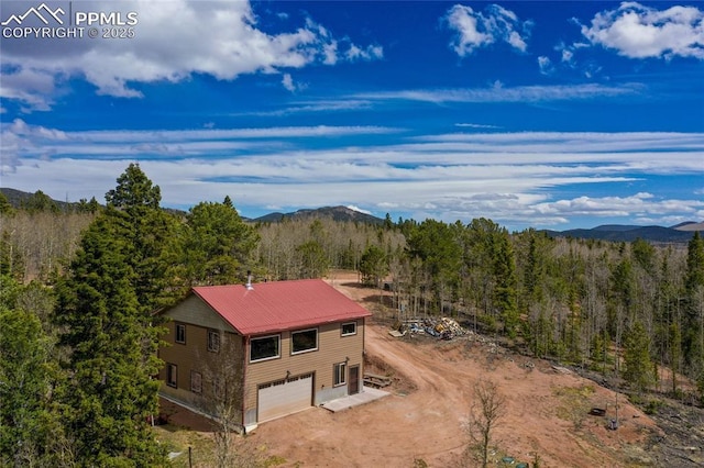 2747 County Road 61, Cripple Creek, CO 80813 - aerial view of property and surrounding area with a forest and a mountain backdrop