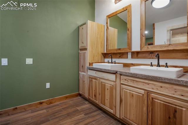 2747 County Road 61, Cripple Creek, CO 80813 - bathroom featuring wood finished floors, double vanity, and baseboards