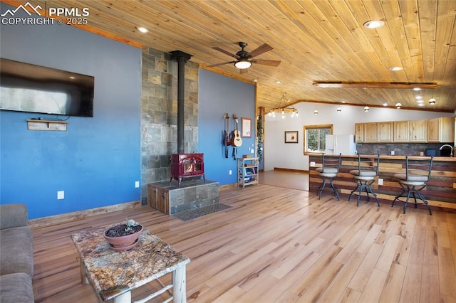 2747 County Road 61, Cripple Creek, CO 80813 - living area with wooden ceiling, lofted ceiling, a wood stove, ceiling fan, and light wood-style floors