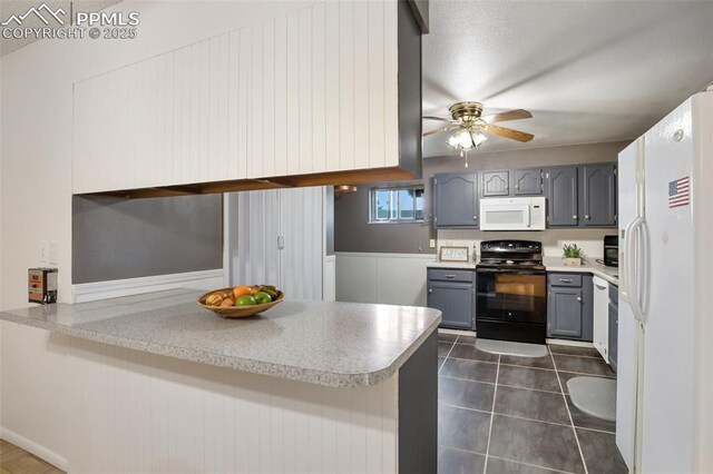 kitchen with white appliances, gray cabinets, a ceiling fan, a peninsula, and light countertops