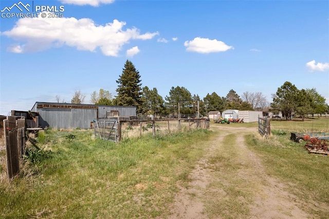view of yard featuring an outbuilding, fence, and an outdoor structure