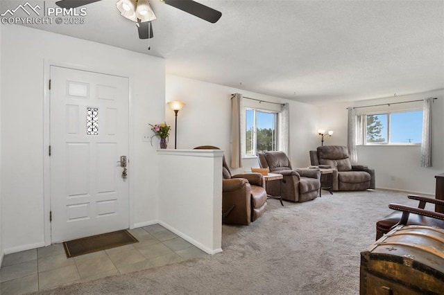 carpeted living room featuring healthy amount of natural light, ceiling fan, and baseboards