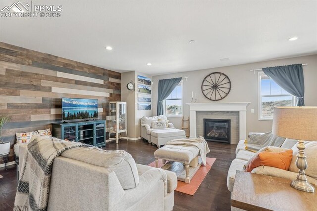 3197 Cool Meadow Pl, Castle Rock, CO 80104 - living room with a glass covered fireplace, plenty of natural light, wood walls, recessed lighting, and wood finished floors