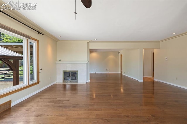 1303 Hermosa Way, Colorado Springs, CO 80906 - unfurnished living room with a tile fireplace, wood finished floors, baseboards, crown molding, and ceiling fan